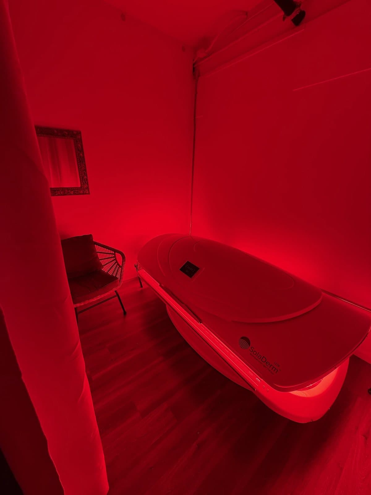 A therapy room lit entirely in deep red light